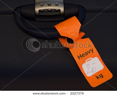stock-photo-an-orange-tag-on-a-heavy-piece-of-luggage-2227379